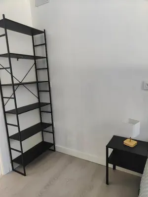 a room with a black book shelf next to a table at Chalet con piscina dogfriendly in Algar de Palancia