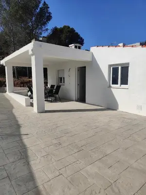 a white house with a patio in front of it at Chalet con piscina dogfriendly in Algar de Palancia