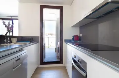 a kitchen with a sink and a counter top at Global Vacacional, Apartamento con piscina en Puerto de Sagunto in Puerto de Sagunto