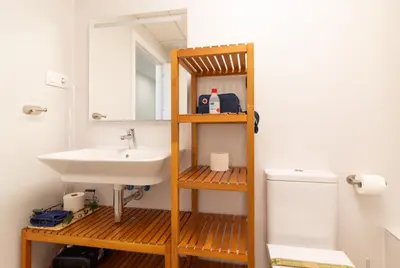 a bathroom with a sink and a toilet at Global Vacacional, Apartamento con piscina en Puerto de Sagunto in Puerto de Sagunto