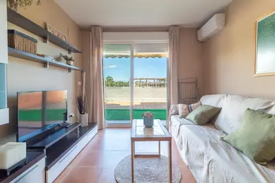 a living room with a couch and a tv at Global Vacacional, Planta baja con piscina en Almenara in Almenara