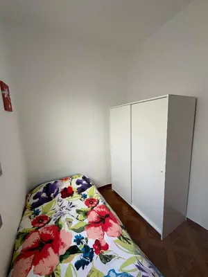 a bedroom with a bed and a white cabinet at Ático en el centro con terraza in Valencia