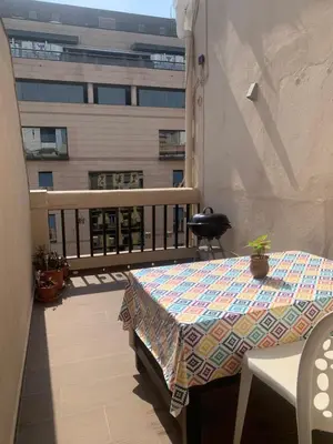 a balcony with a table and a view of a building at Ático en el centro con terraza in Valencia