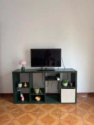 a green table with a television on top of it at Ático en el centro con terraza in Valencia