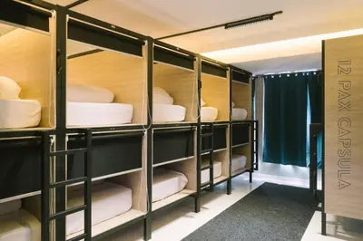 a room with four bunk beds with towels at U-nit Hostel Central Park in Valencia