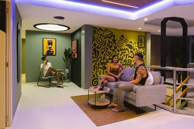 a group of people sitting in a living room at U-nit Hostel Central Park in Valencia