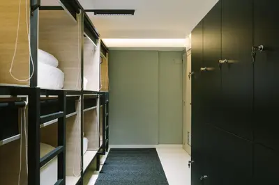 a room with bunk beds and a hallway at U-nit Hostel Central Park in Valencia