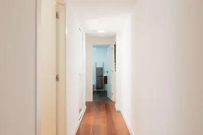 a hallway of a house with white walls and wooden floors at Premium, Lux & Comfort by the Sea in Valencia