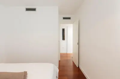 a bedroom with white walls and a white bed at Premium, Lux & Comfort by the Sea in Valencia