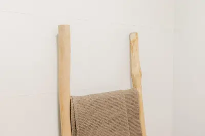 a wooden chair hanging on a white wall at Premium, Lux & Comfort by the Sea in Valencia