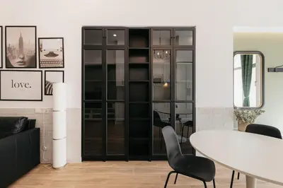 a dining room with a white table and black chairs at New! Comfort and Style Steps from Everything in Valencia