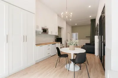 a kitchen and dining room with a table and chairs at New! Comfort and Style Steps from Everything in Valencia