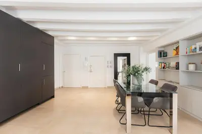a dining room with a glass table and black cabinets at Comfort & Charm in the Center in Valencia