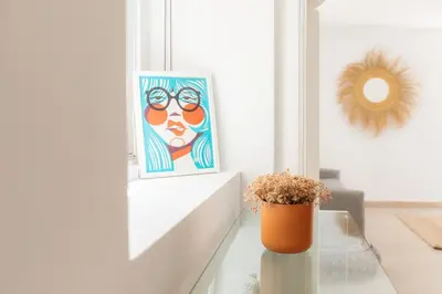 a room with a table with a painting and a vase at Comfort & Charm in the Center in Valencia