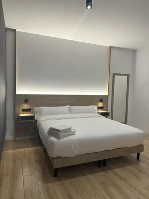 a bedroom with a white bed with a mirror at Valencia Breeze in Alaquas