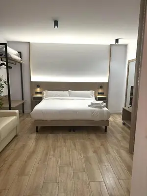 a bedroom with a large bed and wooden floors at Valencia Breeze in Alaquas