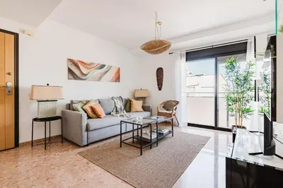 a living room with a couch and a table at Urban Oasis near the beach in Puerto de Sagunto