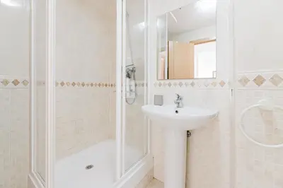 a white bathroom with a sink and a shower at Urban Oasis near the beach in Puerto de Sagunto