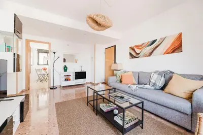 a living room with a couch and a table at Urban Oasis near the beach in Puerto de Sagunto