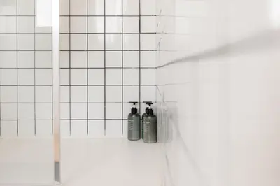 two bottles are sitting on a shelf in a shower at Penthouse with Terrace 2 Bedrooms 2 Bathrooms in Valencia