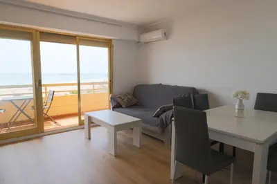a living room with a table and a couch and a table and chairs at Panoramic Mediterranean Views Beachfront in Puerto de Sagunto