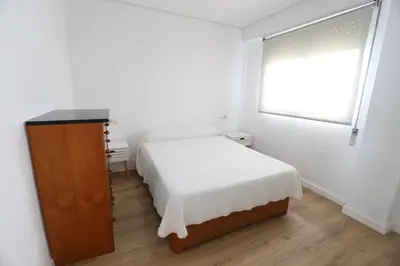 a small bedroom with a bed and a window at Panoramic Mediterranean Views Beachfront in Puerto de Sagunto
