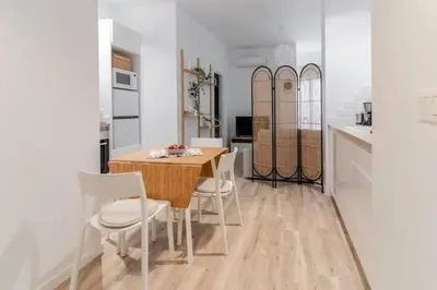 a kitchen with a table and chairs in a kitchen at Super Apto 2habitaciones dobles 4 pax wifi terraza in Valencia
