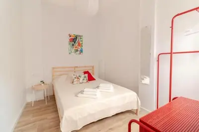 a white bedroom with a bed with towels on it at Super Apto 2habitaciones dobles 4 pax wifi terraza in Valencia