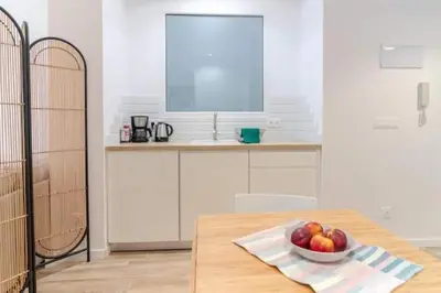 a kitchen with a bowl of fruit on a table at Super Apto 2habitaciones dobles 4 pax wifi terraza in Valencia