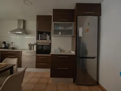 a kitchen with a stainless steel refrigerator at Villa a un paso de Valencia in Riba-Roja De Turia
