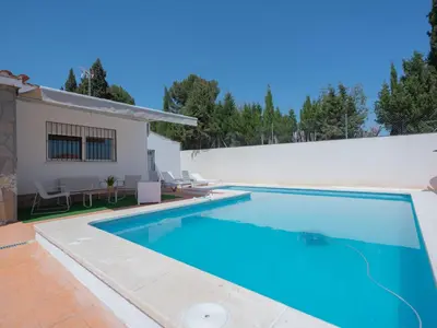 a swimming pool in front of a house at Villa a un paso de Valencia in Riba-Roja De Turia