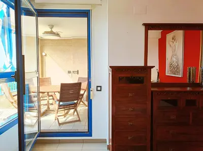 a room with a glass door leading to a dining room at Valencia Playa Patacona Resort in Valencia