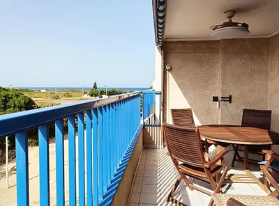 a balcony with a table and chairs and the ocean at Valencia Playa Patacona Resort in Valencia
