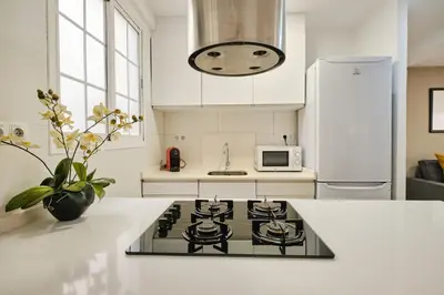 a kitchen with a stove and a white counter top at Serrano flat in Valencia