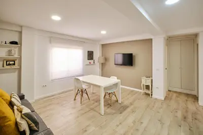 a living room with a white table and a couch at Serrano flat in Valencia
