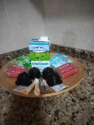 a round wooden plate with a bottle of milk and some medicines at Apartamento en playa de Moncofar con wifi y aire acondicionado in Moncófar