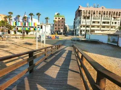 a wooden boardwalk in a city with buildings at Apartamento en playa de Moncofar con wifi y aire acondicionado in Moncófar