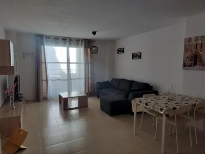 a living room with a couch and a table at Apartamento en playa de Moncofar con wifi y aire acondicionado in Moncófar