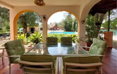 a patio with a glass table and chairs at Awesome Home In Bétera in Bétera