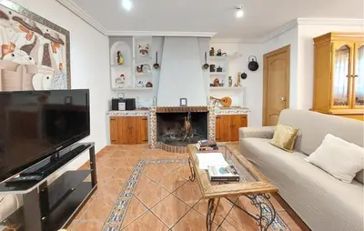 a living room with a couch and a fireplace at Awesome Home In Bétera in Bétera