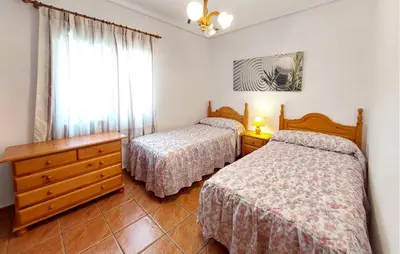 a bedroom with two beds and a dresser and a window at Awesome Home In Bétera in Bétera