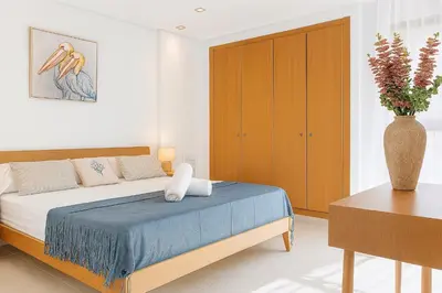 a bedroom with a bed and a vase of flowers at Valencia Beach Home 8 in Valencia