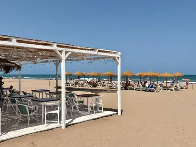 a group of tables and chairs on the beach at Valencia Beach Home 8 in Valencia