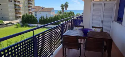 a balcony with a table and chairs and the ocean at Precioso Duplex a orilla del mar y con piscina in Moncófar