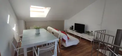 a kitchen with a table and chairs in a room at Precioso Duplex a orilla del mar y con piscina in Moncófar
