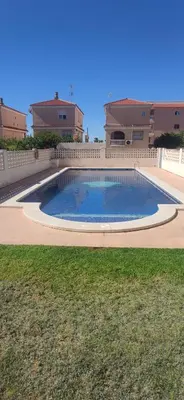 a living room with a table and a television at Precioso Duplex a orilla del mar y con piscina in Moncófar
