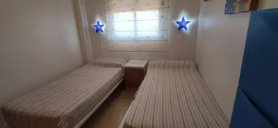 a small room with a bed and two stars on the wall at Precioso Duplex a orilla del mar y con piscina in Moncófar