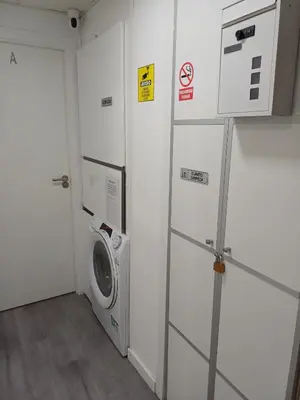 a laundry room with a washer and a washing machine at loft cerca del centro de Valencia in Valencia