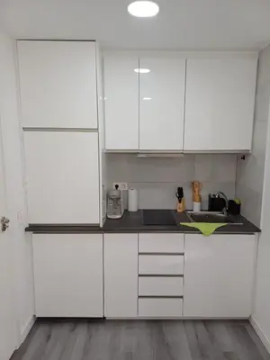 a white kitchen with white cabinets and a sink at loft cerca del centro de Valencia in Valencia