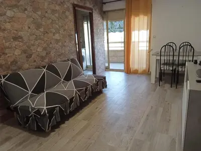 a living room with a couch and a stone wall at Avenida Mediterráneo in Puerto de Sagunto